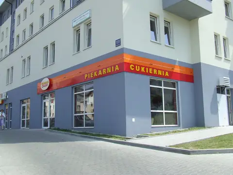 Pas reklamowy piekarni na elewacji budynku